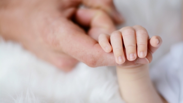 North Houston IVF baby holding parent's finger