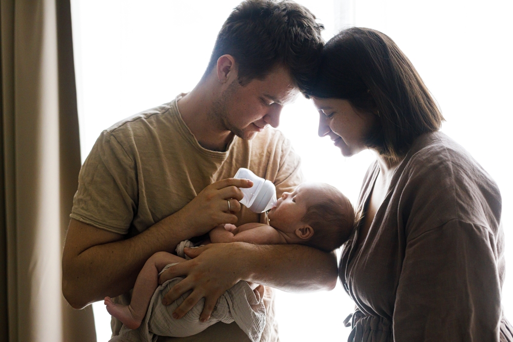 Mom and dad nursing their baby