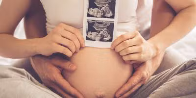 Couple with picture of ultrasound after The Woodlands IVF treatment with donor sperm