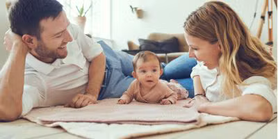 Parents laying on the floor with their north houston ivf baby