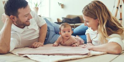 Parents laying on the floor with their north houston ivf baby