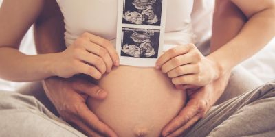 Couple with picture of ultrasound after The Woodlands IVF treatment with donor sperm