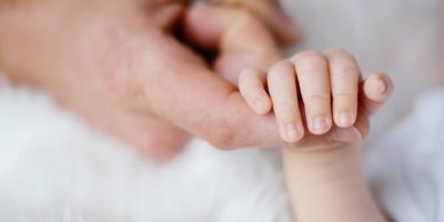 North Houston IVF baby holding parent's finger