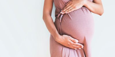 Pregnant woman holding her belly after successful IVF pregnancy
