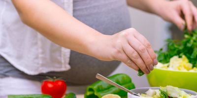 A pregnant woman eating healthy food